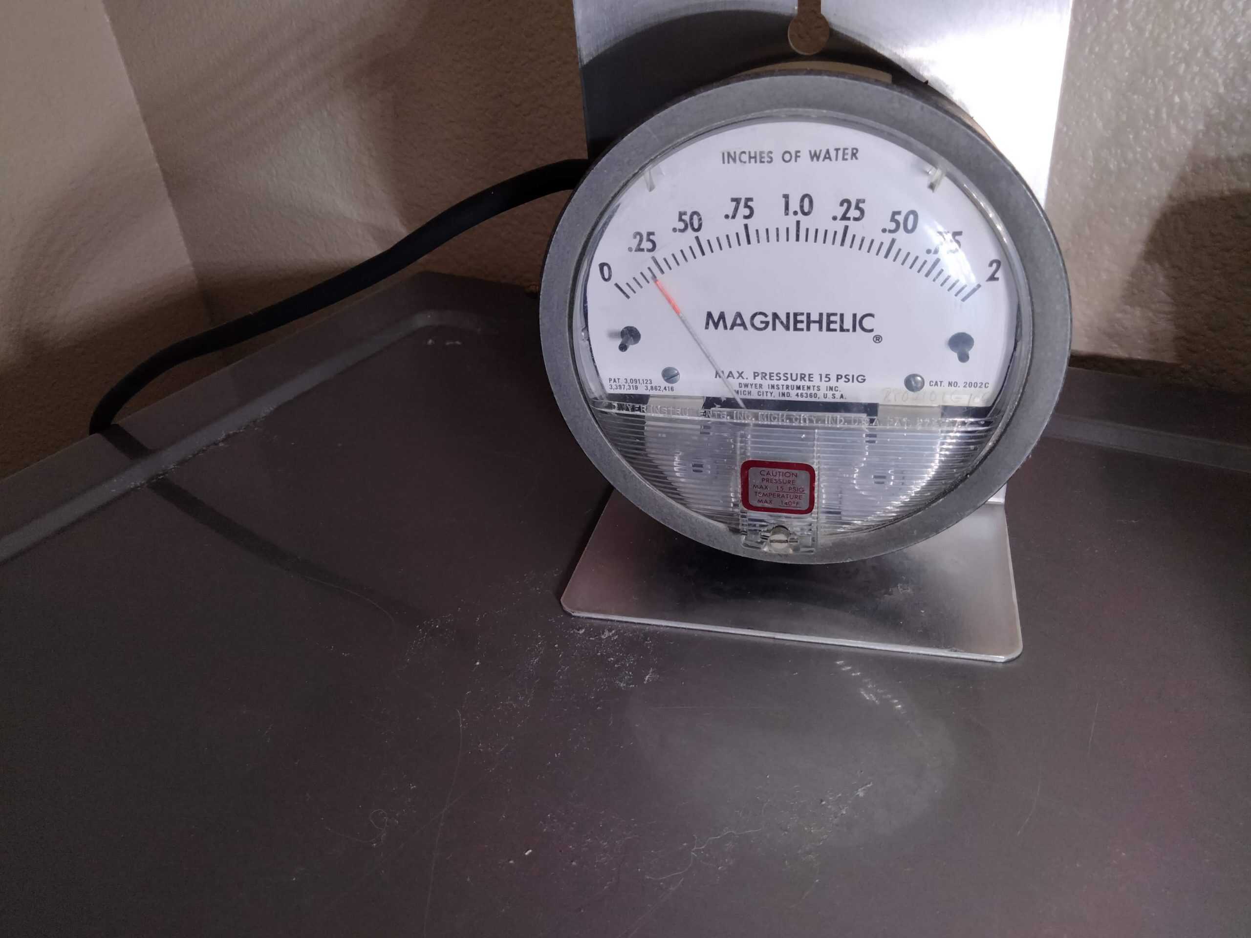 Magnehelic gauge connected — measuring dryer vent static pressure