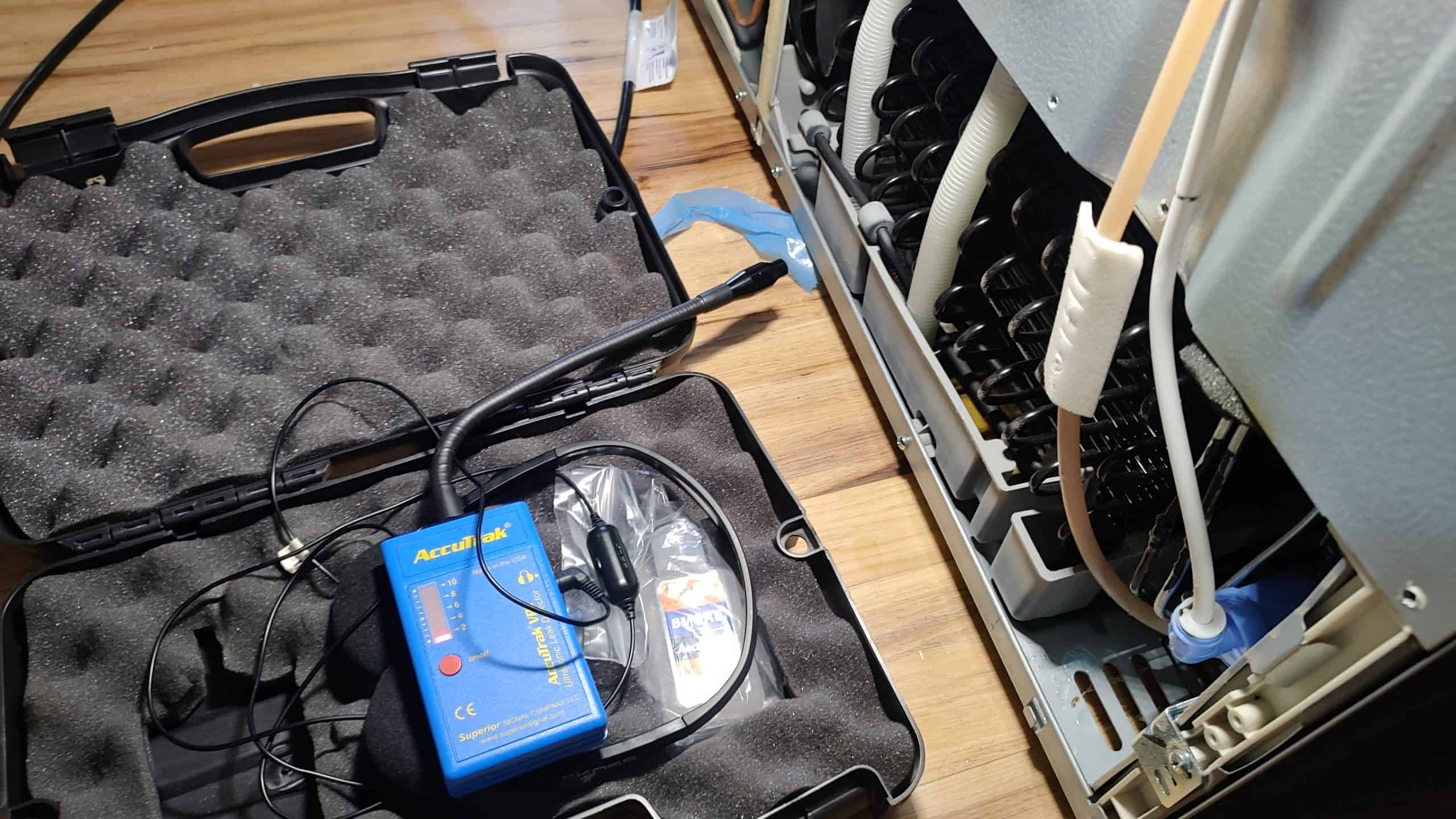 Ultrasonic leak detector used during Frigidaire refrigerator sealed system diagnosis