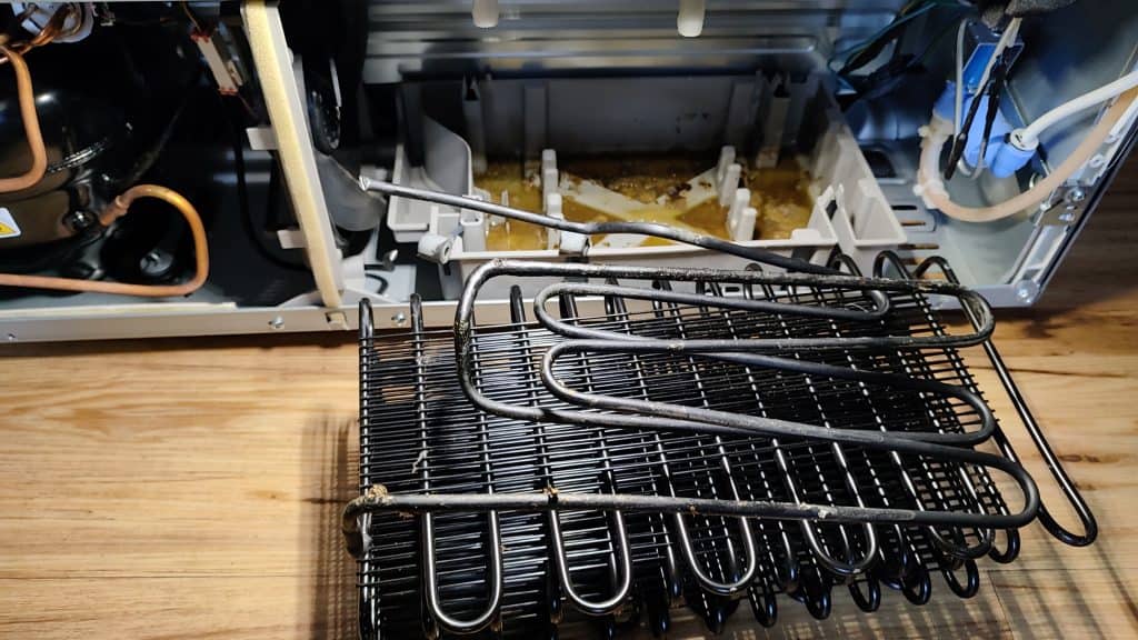 removed-damaged-condenser-coil-frigidaire-prmc2285af-replacement