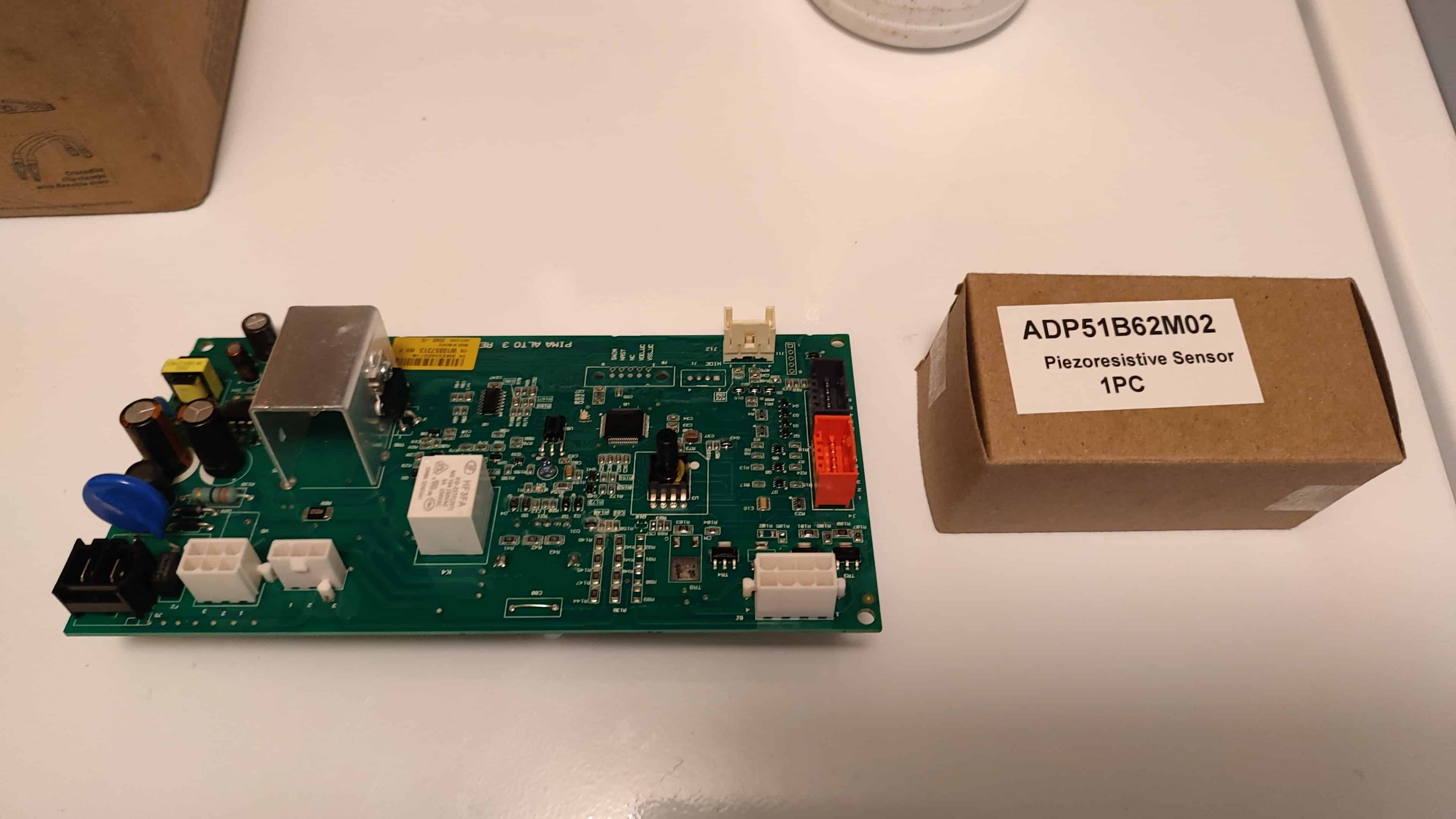 closeup-hand-aligning-new-water-level-sensor-whirlpool-pcb