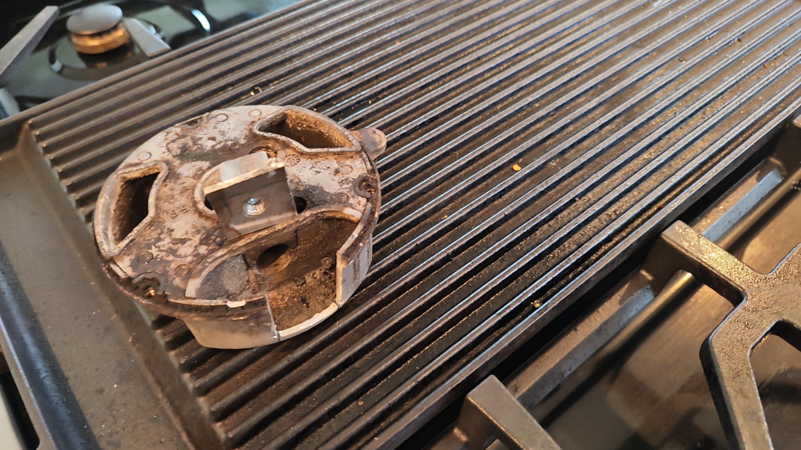 ZLINE burner cut open to remove seized gas orifice safely