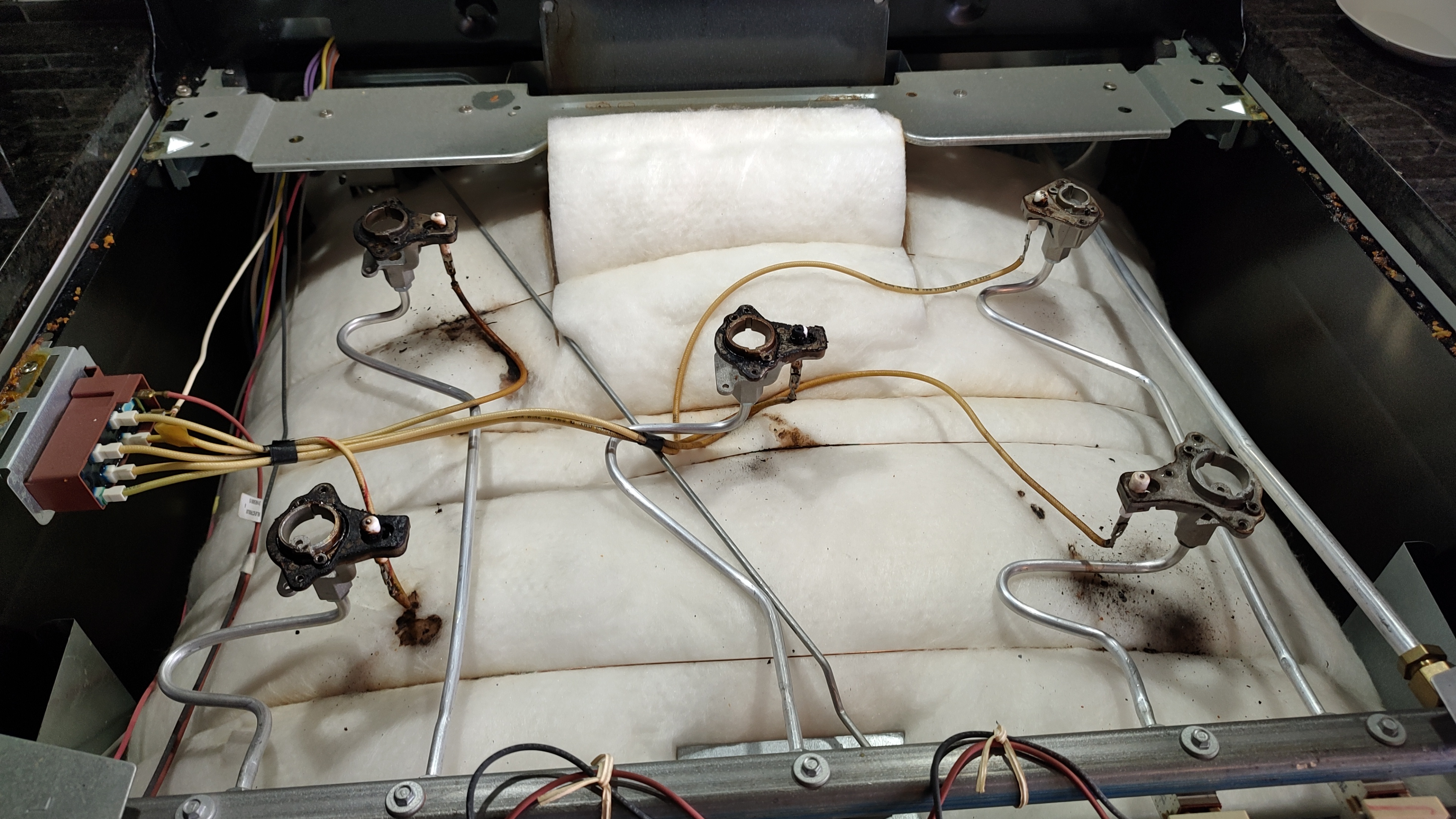 Frigidaire Gas Range Burners Not Igniting – Spark Module Replacement (Beaverton, WA) 5 Frigidaire gas range cooktop disassembled for burner inspection and ignition system cleaning during repair