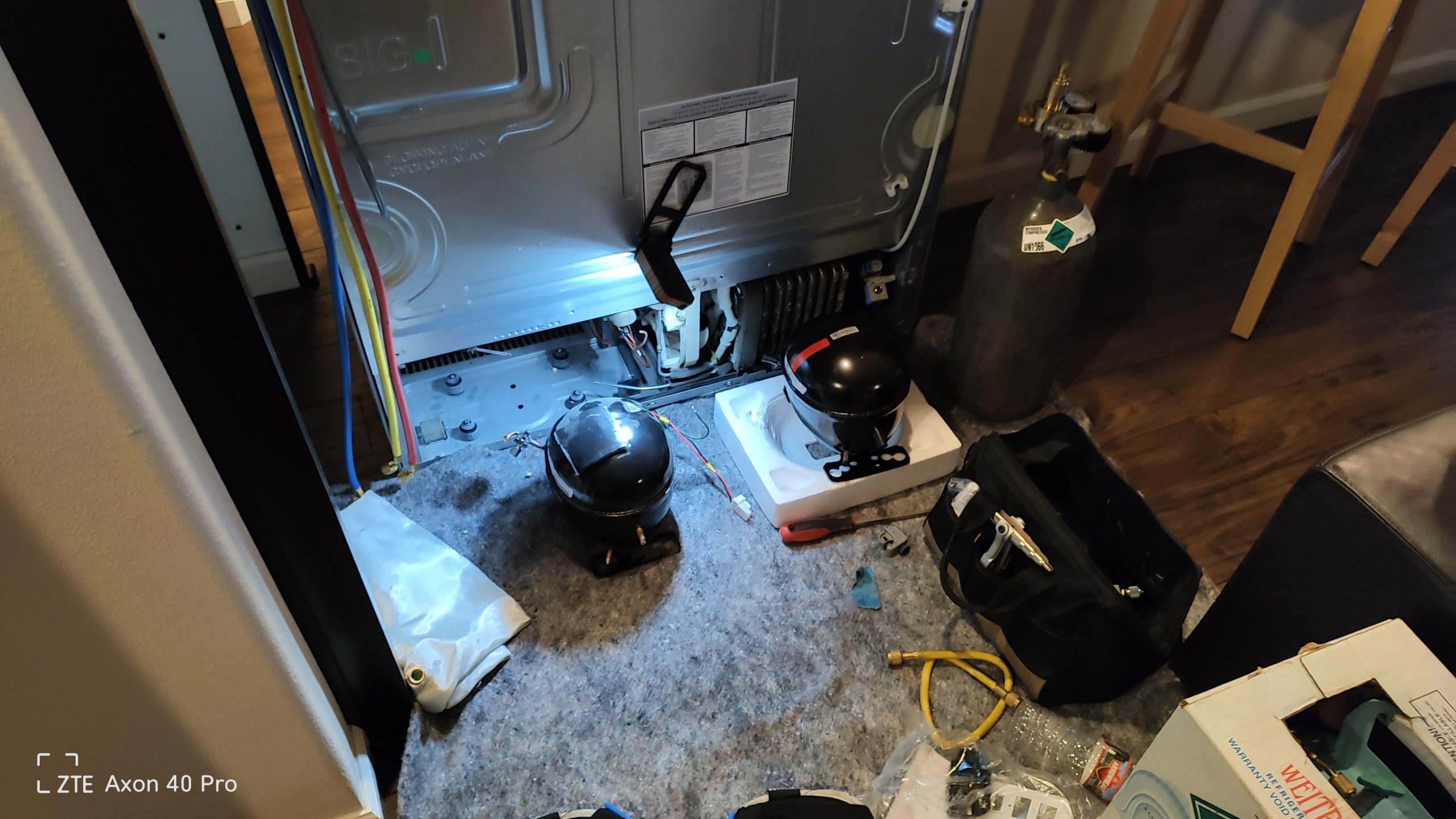 Refrigerator compressor removed during sealed system repair in Vancouver WA