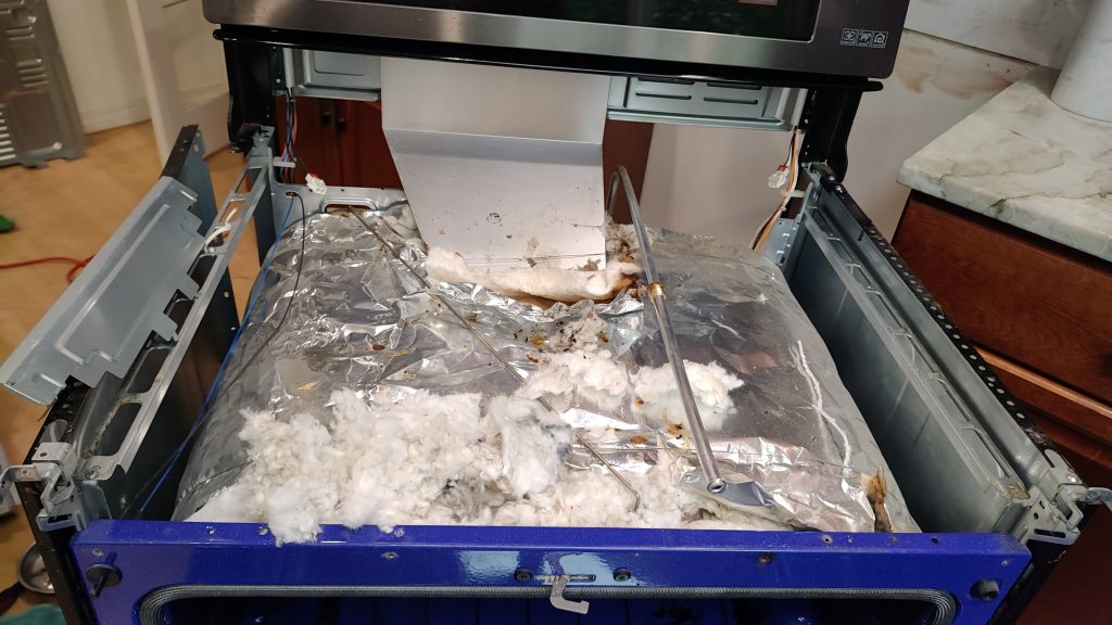 Contaminated oven insulation inside LG gas range after rodent damage in Camas WA