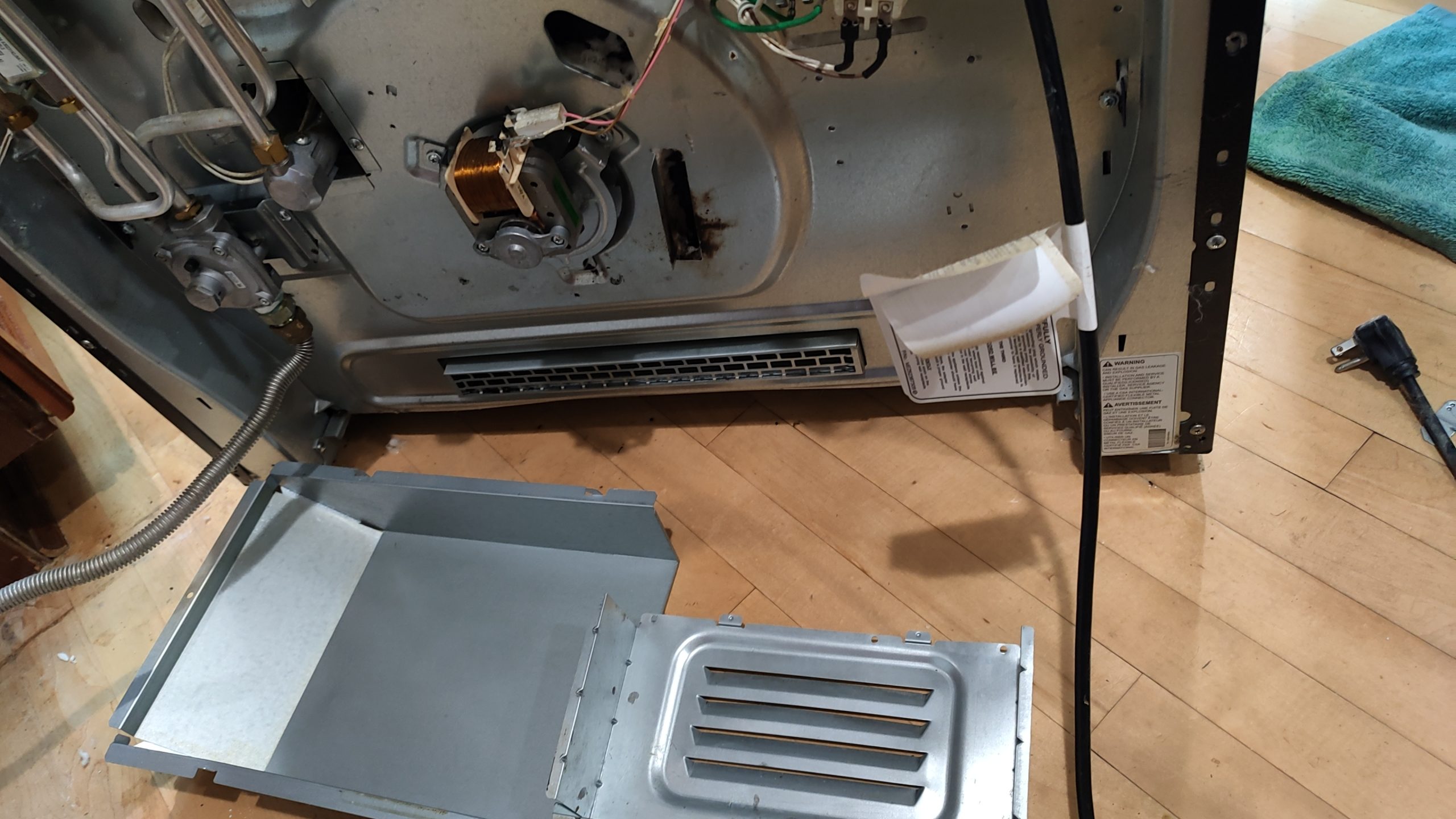 Rear panel of LG gas range cleaned after rodent damage repair in Camas WA