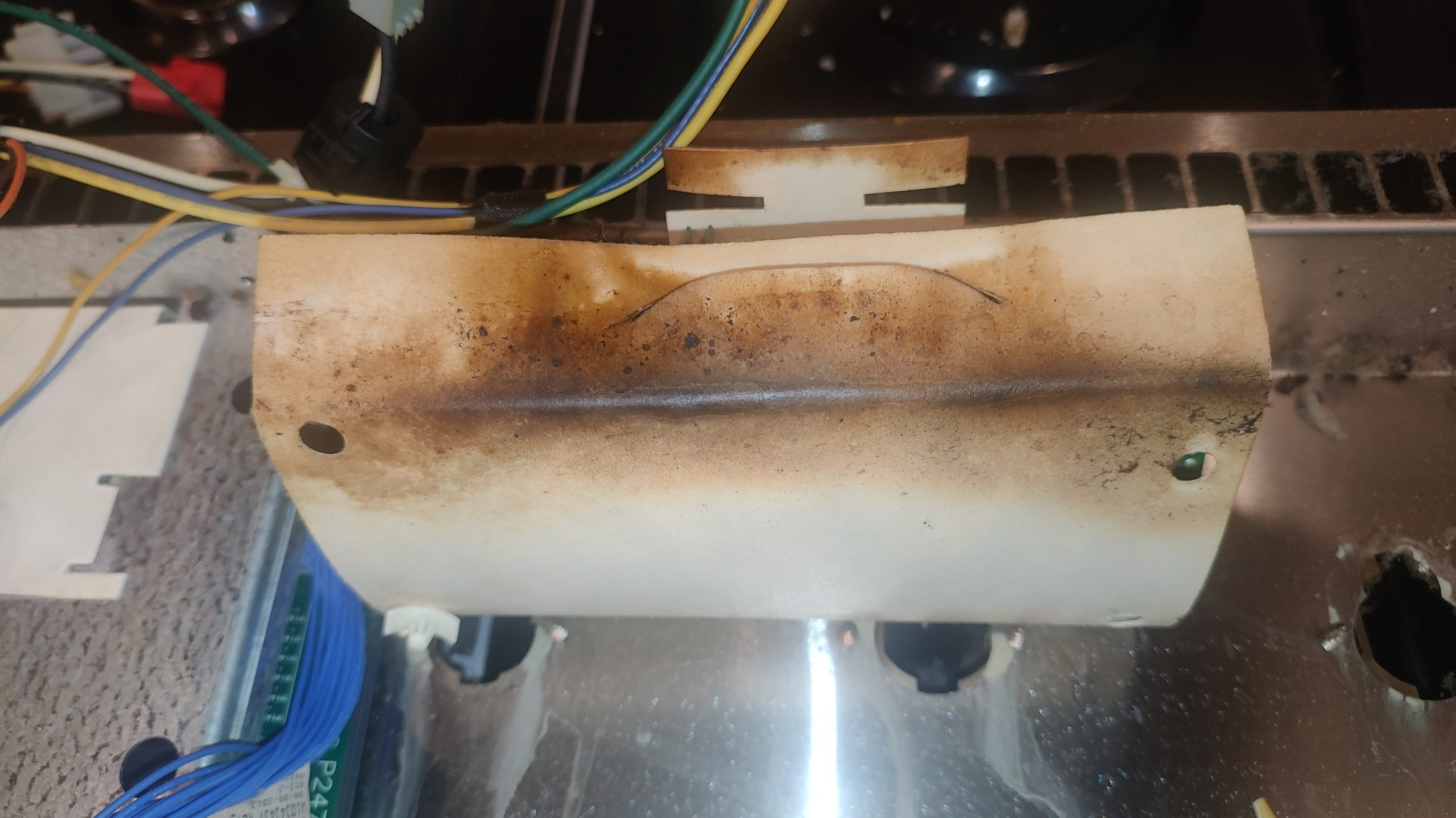 Scorched insulation near the control board area inside a JennAir gas range